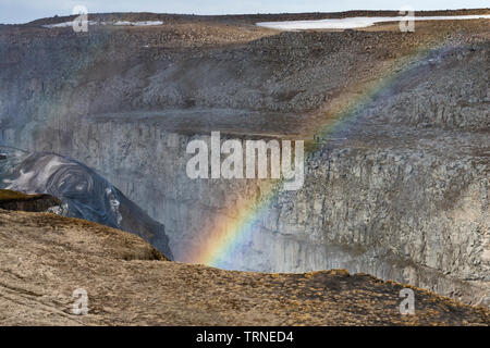 Un arcobaleno appare nello spruzzo dall'enorme di Dettifoss cascata nel Vatnajökull PARCO NAZIONALE, NE L'Islanda. Foto Stock