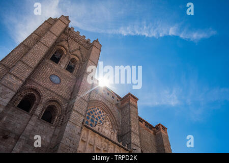 Vista principale della Cattedrale di Avila, Spagna, con sole e nubi in un cielo blu Foto Stock