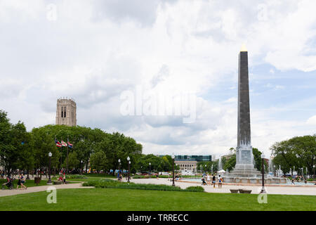 Indianapolis, Indiana, Stati Uniti d'America - 25 Maggio 2019 - Persone a godersi la giornata presso la Piazza Obelisco Fontana con la Scottish Rite Cathedral e la Indianapolis Foto Stock