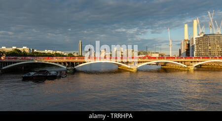 London, England, Regno Unito - 28 Maggio 2019: un treno Gatwick Express che passa Battersea Power Station come si attraversa il fiume Tamigi nella zona ovest di Londra. Foto Stock