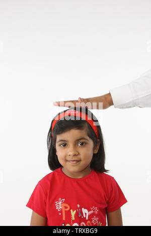 Person hand on a girl head Stock Photo