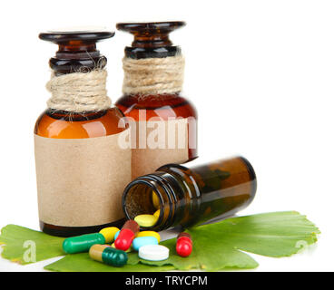 Foglie di Ginkgo biloba e medicina di bottiglie con le pillole isolato su bianco Foto Stock