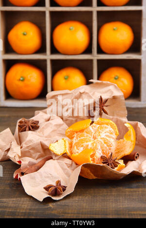 Mature sweet tangerini in cassetta di legno,su sfondo di legno, close-up Foto Stock