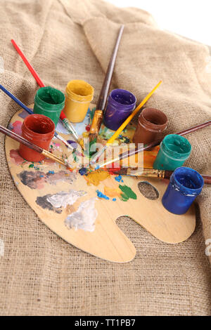 Composizione con spazzole, acquerelli su palette in legno, isolato su bianco Foto Stock