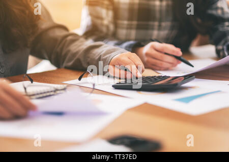 Primo piano immagine di un imprenditore utilizzando la calcolatrice in una riunione di affari Foto Stock