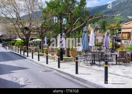 Archanes, isola di Creta / Grecia. La piazza centrale di Archanes Village con il vecchio tradizionale caffè e ristoranti Foto Stock