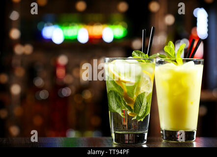 Bicchieri di cocktail al bar sulla luminosa sfondo sfocato Foto Stock