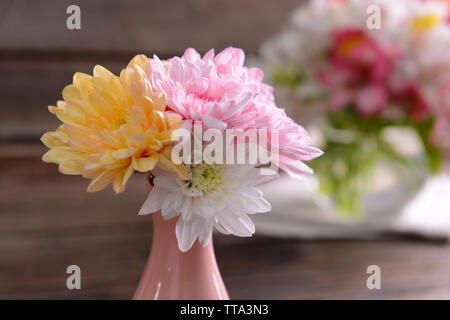 Bellissimi vasi con fiori sul tavolo vicino fino Foto Stock