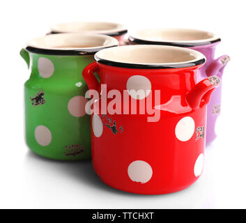 Vecchio colorate lattine di latte con la polka dots, isolato su bianco Foto Stock