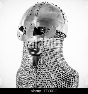 Metallo, Viking casco con la catena posta in un manichino nero su sfondo bianco. i vestiti per la guerra viking Foto Stock