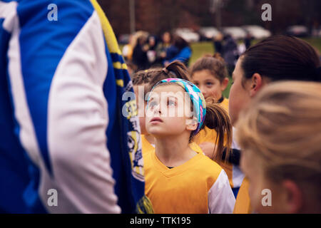 Calcio femminile player guardando al coach permanente, mentre con il team nel campo Foto Stock