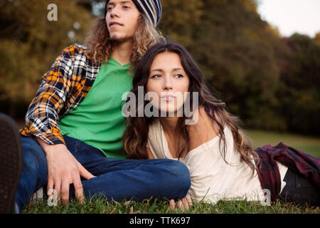 L uomo e la donna rilassante sul campo erboso Foto Stock