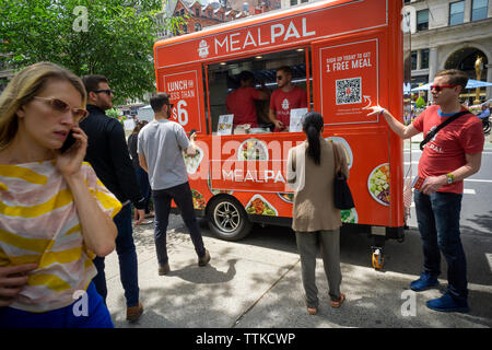 I lavoratori da MealPal in corrispondenza di un carrello tenta di firmare i deputati per il loro abbonamento servizio pasti al di fuori del Madison Square Park di New York il Mercoledì, 12 giugno 2019. Il servizio di abbonamento offre al sacco da numerosi ristoranti locali per un prezzo fisso per ogni pasto. (© Richard B. Levine) Foto Stock