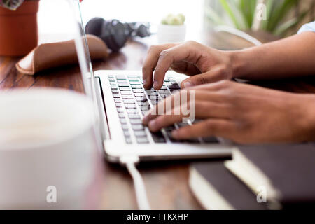 Immagine ritagliata di imprenditore creativo utilizzando laptop alla scrivania Foto Stock