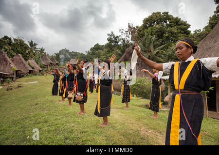 INDONESIA, Flores, Ngadha District, i residenti del villaggio Belaraghi ballare e cantare per dare il benvenuto agli ospiti nel loro villaggio Foto Stock