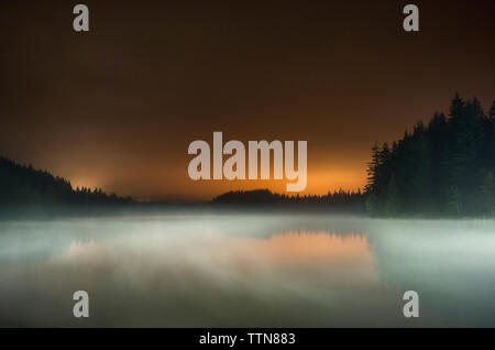 Una lunga esposizione di nebbia sul lago a Mt cappa Foresta Nazionale contro il cielo durante il tramonto Foto Stock