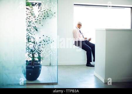 Medico che lavorano su computer tablet in ospedale lobby Foto Stock