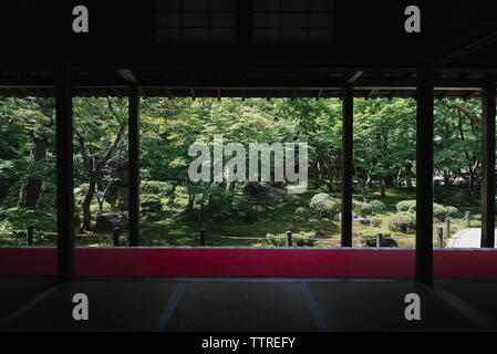 View of formal garden seen through building Foto Stock