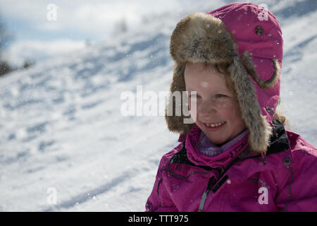 Felice ragazza sorridente nel paese delle meraviglie invernali con la neve Foto Stock