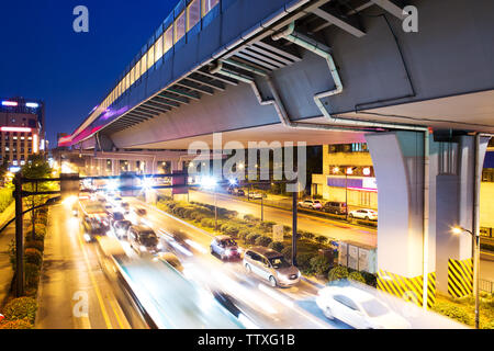 Del traffico su strada sotto il viadotto Foto Stock