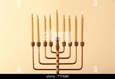 Il Menorah con candele per Hanukkah su sfondo chiaro, close up Foto Stock