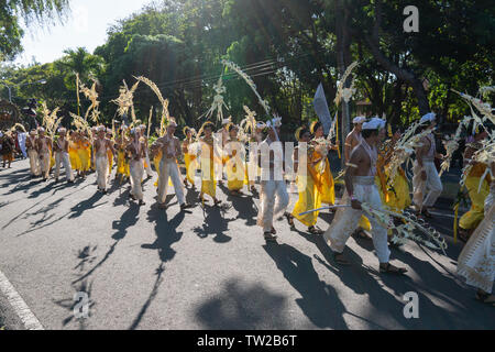 DENPASAR/BALI-Giugno 15 2019: Sampian ballerino, indossando giallo e bianco costume tradizionale, camminando per eseguire a Bali Arts Festival 2019. Essi utilizzano palm Foto Stock