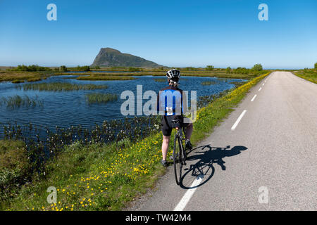 Ciclista femmina in Gimsoya, Isole Lofoten in Norvegia. Foto Stock