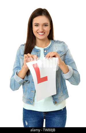 Giovane donna strappo allievo conducente segno su sfondo bianco Foto Stock