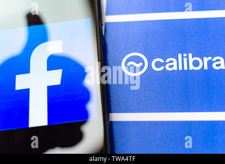 Logo di Facebook sullo schermo e la brochure con Calibra logo. A titolo illustrativo per notizie su Facebook cryptocurrency e portafogli digitale app. Foto Stock