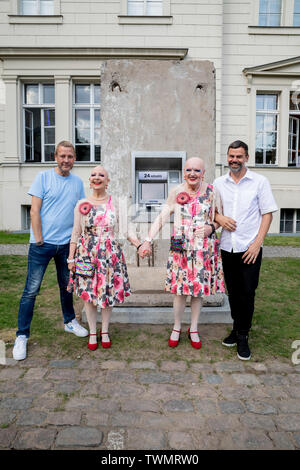 Berlino, Germania. Il 21 giugno, 2019. Michael Elmgreen (l) e Ingar Dragset (r), insieme all'artista Danish-Norwegian duo Elmgreen e Dragset, stand con l'artista giovane Eva & Adele (M) nella parte anteriore della loro scultura 'Statue di liberta' nel cortile di Hamburger Bahnhof. La scultura da 2018 è costituito da un segmento di calcestruzzo del muro di Berlino in cui un functionless cash dispenser è integrato. Il lavoro è stato donato dal collettore Heiner Wemhöner e viene presentato come un permanente di sculture all'aperto. Credito: Christoph Soeder/dpa/Alamy Live News Foto Stock