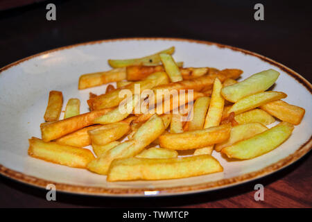 Porzione di freschi pommes frites o patatine fritte patatine fritte in un piatto bianco. Foto Stock