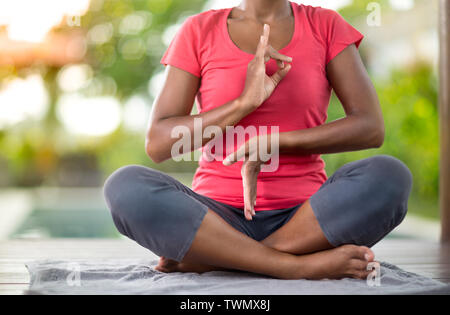 Lo Yoga. Giovane donna asiatica facendo esercizi yoga outdoor Foto Stock