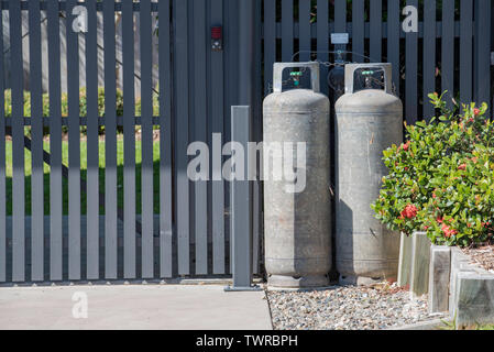 Il GPL o Gas di Petrolio Liquido bottiglie conservate e collegata a una casa in Australia Foto Stock