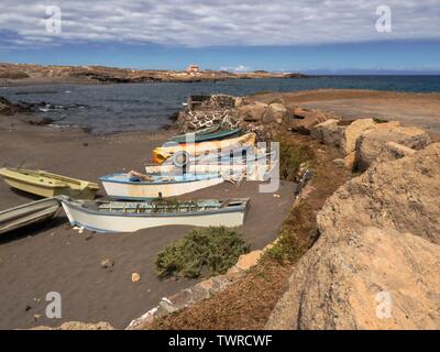 Piccolo e vecchio di legno barche da pesca, dipinte di colori vivaci, sono situati sul nero Volcanicsand-la spiaggia proprio di fronte all'Oceano Atlantico nel villaggio un Foto Stock