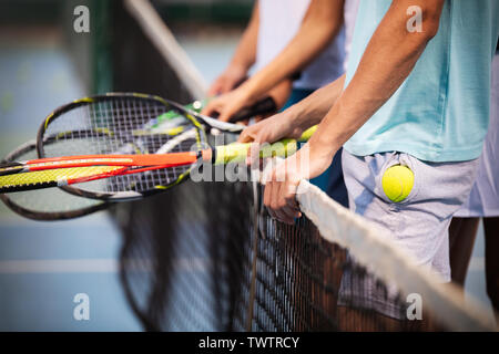 Montare felice la gente giocando a tennis insieme. Sport concept Foto Stock