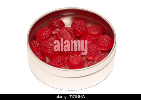 Rosso candy canes caramelle in scatola di stagno su sfondo bianco Foto Stock