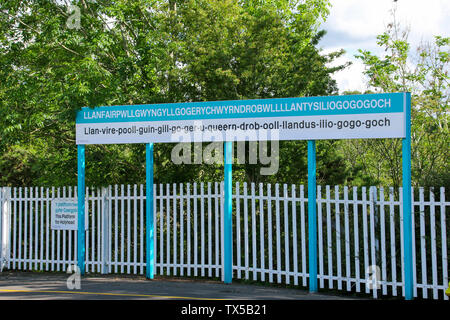 Segno di stazione a Llanfairpwllgwyngyllgogerychwyrndrobwllllantysiliogogogoch, Llanfair PG, Anglesey, Galles del Nord, Wales, Regno Unito Foto Stock