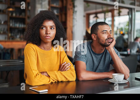 Triste e arrabbiato coppia giovane nel café Foto Stock