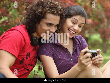 College students looking at video playback in digital camera Stock Photo