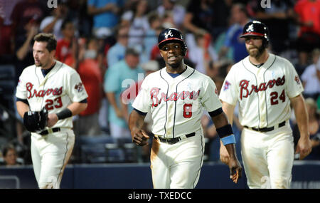 Atlanta Braves' Justin Upton (8) e Evan Gattis (24) punteggio sul compagno di squadra Tommy La Stella di double contro la Los Angeles angeli ma Chris Johnson (23) è stato tagged presso la piastra durante il sesto inning al Turner Field di Atlanta, 15 giugno 2014. UPI/David Tulis Foto Stock