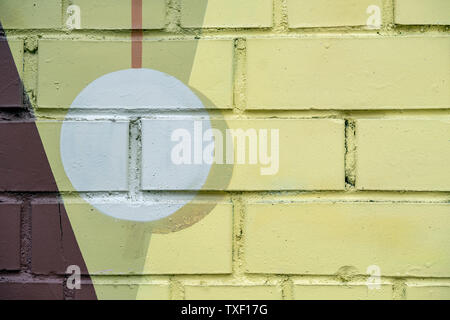 Prelevate il cerchio bianco sulla luce di un mattone giallo la superficie di parete, come graffiti. Graphic abstract background moderno. Moderna icona di cultura urbana, modello elegante Foto Stock