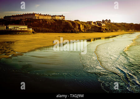 WHITBY in Inghilterra. La gente camminare sulla spiaggia di Whitby su un fine soleggiato, giornata di vento. A Whitby, North Yorkshire, Inghilterra. Foto Stock