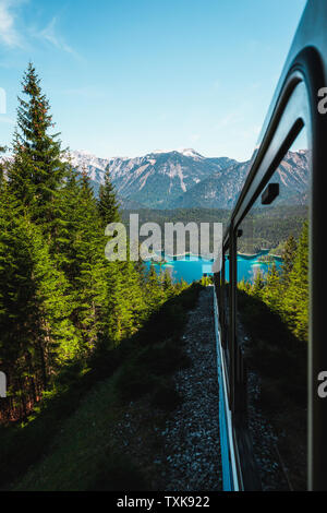 Vista su crystal clear Eibsee come visto dall'interno Zugspitzbahn / Zugspitz bavarese Railway durante la salita alla Germanie la montagna più alta (Germania) Foto Stock