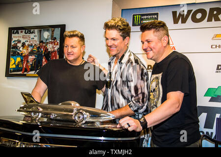 Rascall Flatts (da sinistra a destra) Joe Don Rooney, Gary LeVox e Jay DeMarcus posano con la Daytona 500 Harley J Earle Trofeo al Daytona International Speedway su Febbraio 18, 2018 a Daytona, Florida. Foto di Edwin Locke/UPI Foto Stock