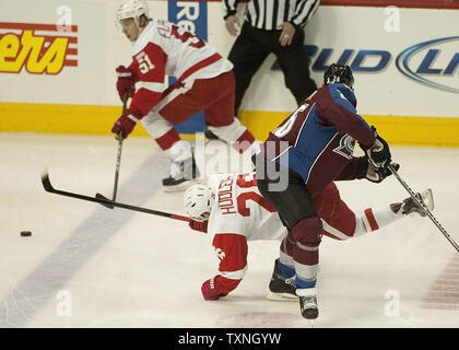 Colorado Avalanche center Paul Stastny (R) upends ali rosse di Detroit center Jiri Judler (26) dopo il suo pass per la presenza di striature di squadra Valtteri Filppula (51) durante il primo periodo presso il Pepsi Center il 4 dicembre 2011 a Denver. Detroit si prefigge di estendere la serie vincente a otto giochi come estremità di Colorado è otto gioco homestand. UPI/Gary Caskey C. Foto Stock