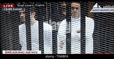 Immagine video prelevati da Stato egiziano spettacoli televisivi Alaa Mubarak, L e Gamal Mubarak, R, figli di Hosni Mubarak, all'interno di una gabbia in un aula di tribunale del Cairo, 3 agosto 2011. Mubarak e i suoi due figli, Alaa e Gamal, sono provati per le accuse di corruzione e di ordinare l'uccisione di manifestanti durante la rivoluzione che ha terminato il suo regno dopo 18 giorni di protesta popolare. UPI/Debbie Hill Foto Stock