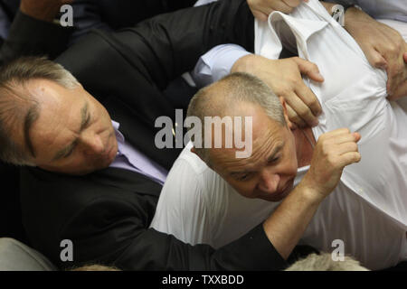 Legislatori ucraino dal regime comunista e a destra Svoboda (Libertà) partito lotta durante una sessione del Parlamento a Kiev il 23 luglio 2014. UPI/Ivan Vakolenko Foto Stock