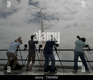 Dal tetto del gruppo del veicolo edificio, fotografi catturare finale della NASA Space Shuttle Launch at 11:29 AM da complesso 39a al Kennedy Space Center, Florida il 8 luglio 2011. Il lancio con un equipaggio di quattro per la Stazione Spaziale Internazionale, la Missione STS 135, è finale della NASA nella missione dello shuttle 30 anni di storia. Ora che la stazione per la costruzione è completa, Atlantis consegnerà le forniture e le attrezzature per essere utilizzato presso il complesso durante il post era navetta. Da questo punto in poi, la stazione sarà fornito da con o senza presidio russo razzi Soyuz. SpaceX è inoltre pianificare Foto Stock