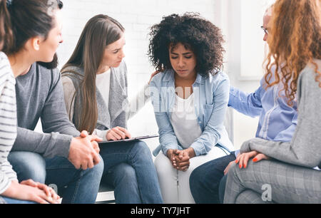 Comprendere le persone dando sostegno a premuto il pianto donna africana Foto Stock