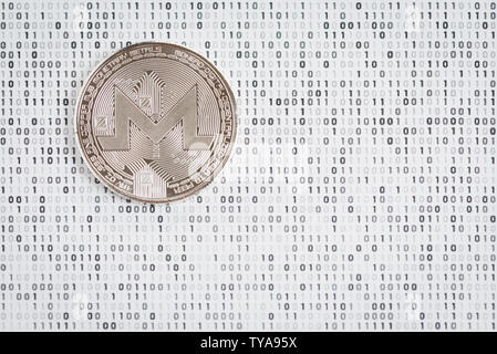 Cryptocurrency coin - argento Monero sul bianco e nero binario 1 e 0 lo sfondo Foto Stock